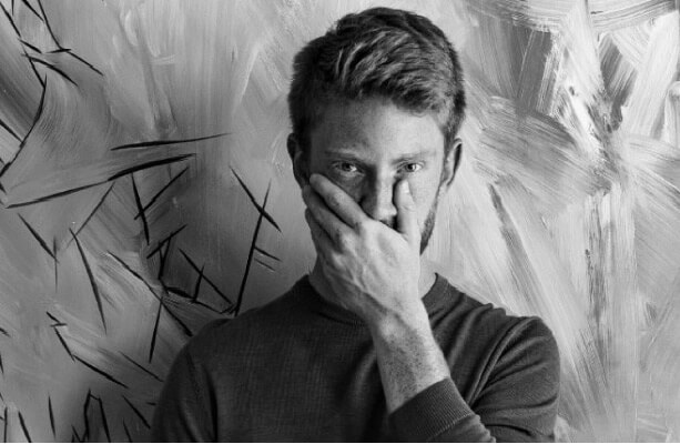 man-covering-his-mouth-1 img