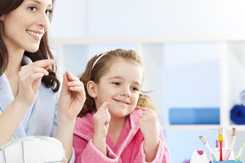kid flossing teeth