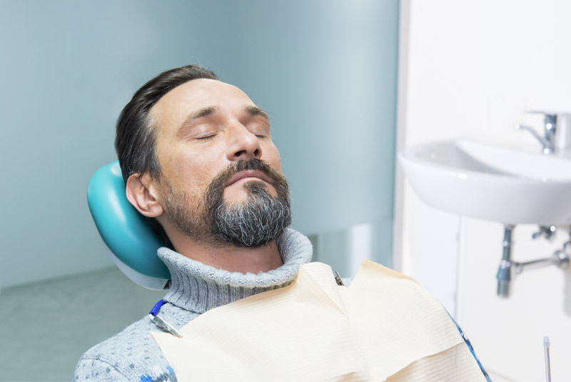 Guy resting sound asleep in dental chair