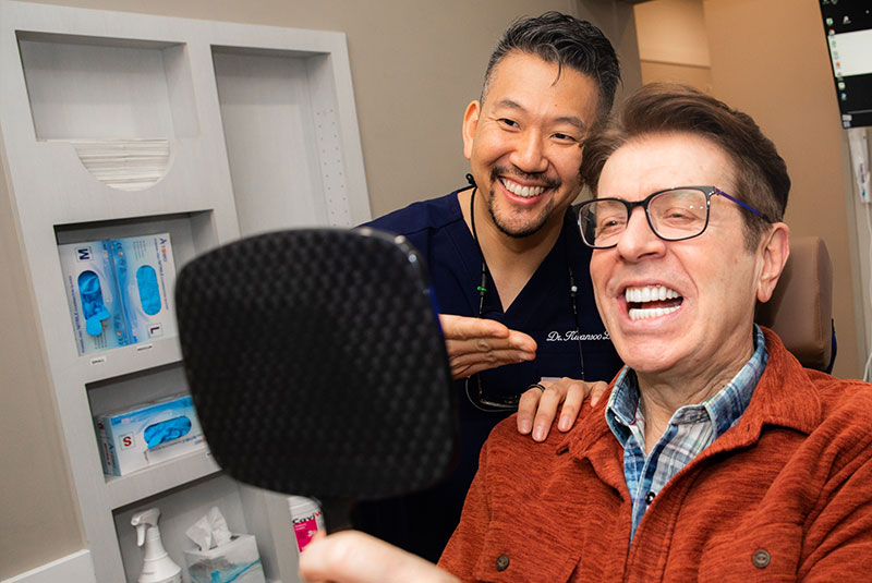 Patient smiling into mirror