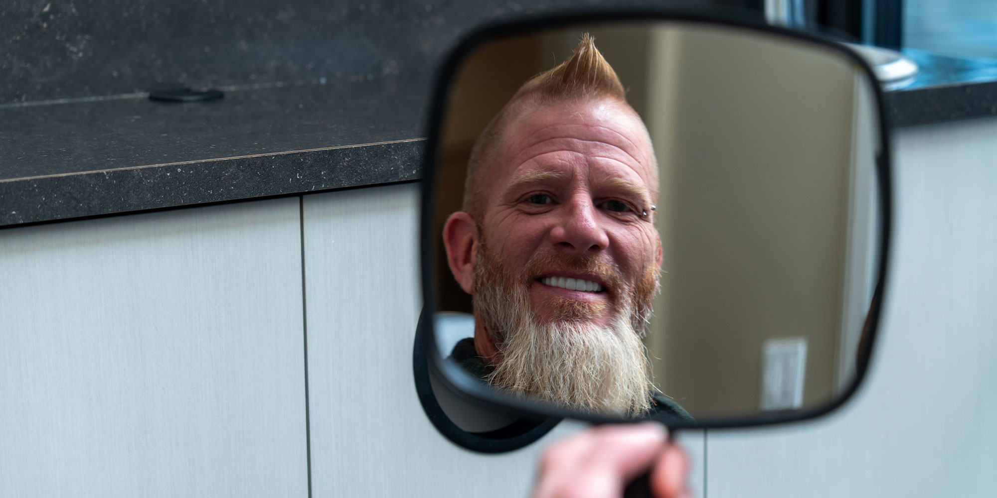 Patient smiling into the mirror