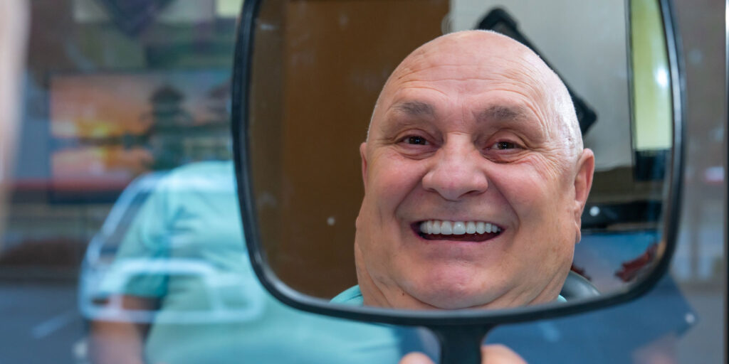 Patient Smiling into mirror